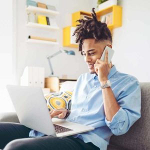 de man on phone and laptop 900x900